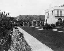Pasadena, California, Mrs. Herbert Coppell home - view of formal lawn, gardens, and hills..., 1917. Creator: Frances Benjamin Johnston