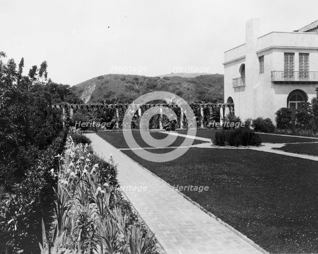 Pasadena, California, Mrs. Herbert Coppell home - view of formal lawn, gardens, and hills..., 1917. Creator: Frances Benjamin Johnston.