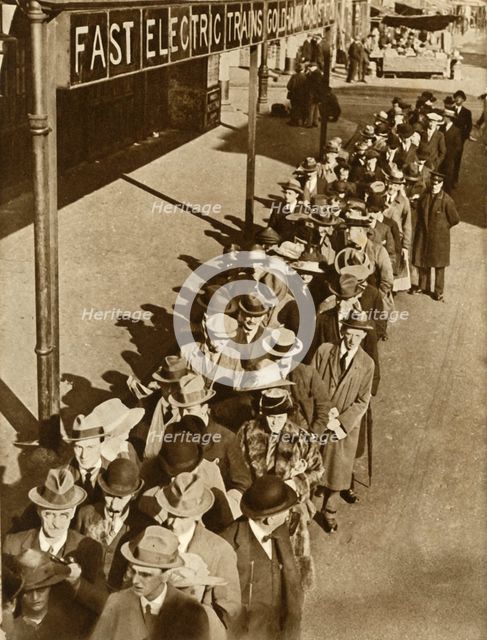 Passengers waiting at Goldhawk Road Station in London during the railway strike, 1919, (1935). Creator: Unknown.