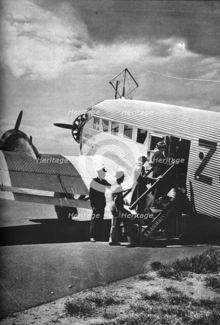 Passengers boarding one of the Junkers airliners of South African Airways, c1936 (c1937). Artist: Unknown.