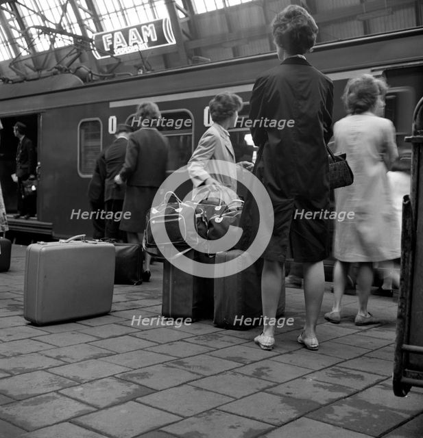 Passengers on a platform at Centraal Station, Amsterdam, Netherlands, 1963. Artist: Michael Walters