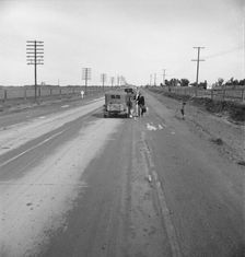 Passing motorist gives walking family of seven a lift to the next town, California, 1939. Creator: Dorothea Lange