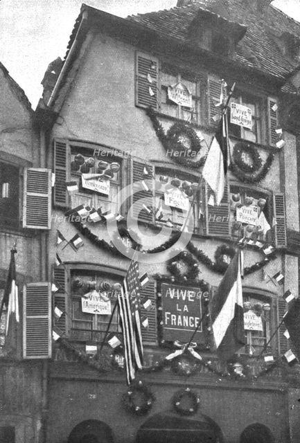 'Petain et Foch a Strasbourg; La parure de fete de Strasbourg liberee: deux facades ornees...,1918. Creator: Unknown.