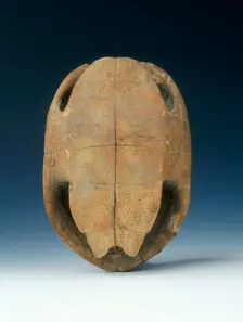 Petrified tortoise shell with oracle bone inscriptions, possibly Shang Dynasty, China, c1400 BC. Creator: Unknown