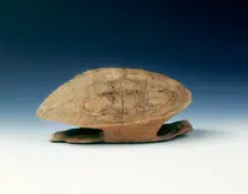 Petrified tortoise shell with oracle bone inscriptions, possibly Shang Dynasty, China, c1400 BC. Creator: Unknown