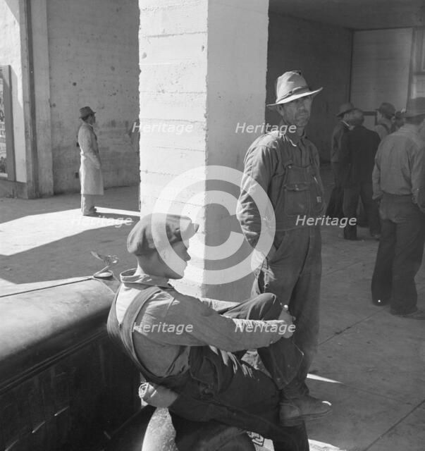 Pea pickers waiting at FSA office for issue of surplus commodities, Calipatria, California, 1939. Creator: Dorothea Lange.