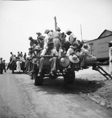 Peach pickers being driven to the orchards, Muscella, Georgia, 1936. Creator: Dorothea Lange