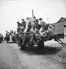 Peach pickers being driven to the orchards, Muscella, Georgia, 1936. Creator: Dorothea Lange