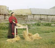 Peasant woman breaking flax;Perm Province, 1910. Creator: Sergey Mikhaylovich Prokudin-Gorsky