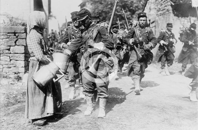 Peasant giving drink to French soldiers, between c1914 and c1915. Creator: Bain News Service.
