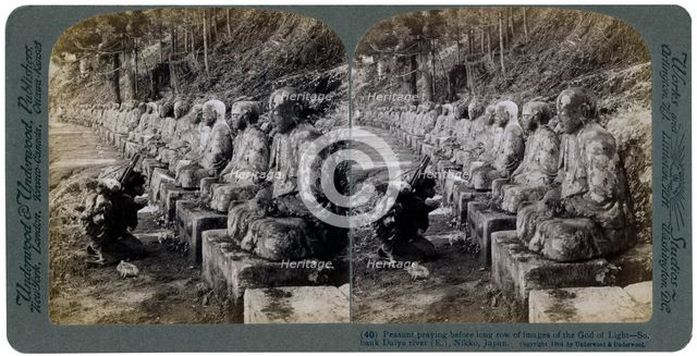 Peasant praying before a row of statues of the God of Light, Daiya river, Nikko, Japan, 1904.Artist: Underwood & Underwood