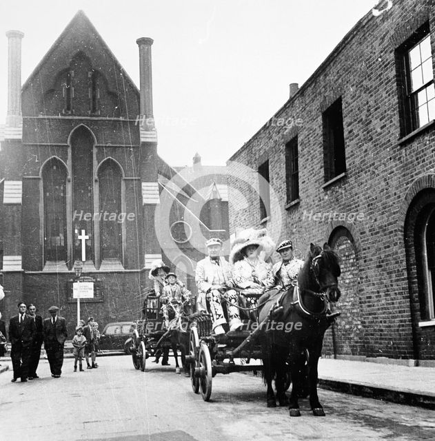 Pearly king and queen riding through London in a carriage, c1950s. Creator: Unknown.