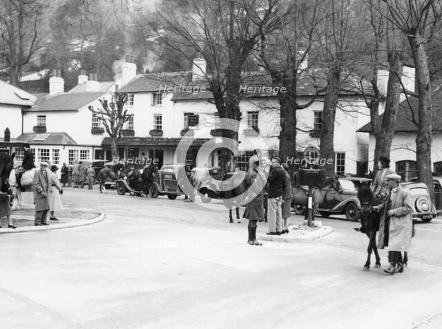 Pedestrians and riders outside the Burford Bridge Hotel, Surrey, (c1930s?). Artist: Unknown