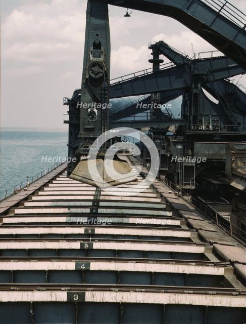 Pennsylvania R.R. iron ore docks, unloading ore from a lake freighter...ore unloaders, 1943. Creator: Jack Delano.