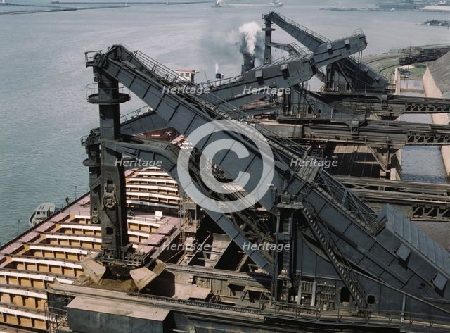 Pennsylvania R.R. ore docks, unloading iron ore from a lake freighter..., Cleveland, Ohio, 1943. Creator: Jack Delano.