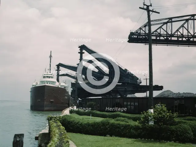 Pennsylvania R.R. [Railroad] ore docks, unloading iron ore from a lake..., Cleveland, Ohio, 1943. Creator: Jack Delano.