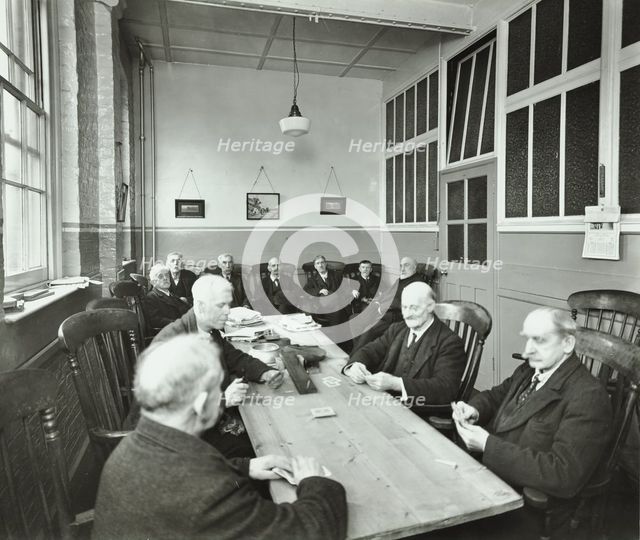 Pensioners playing cards in the Men's Day Room, Lambeth Home for Aged Poor, London, 1935. Artist: Unknown.
