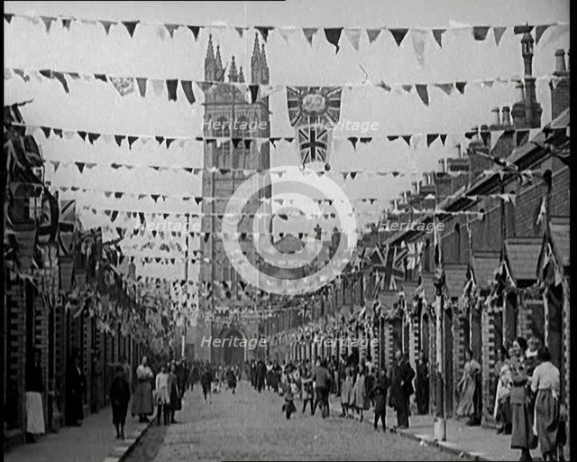 People Out the Front of Their Houses in a Street Decorated With Union Flag Bunting in Belfast, 1921. Creator: British Pathe Ltd.