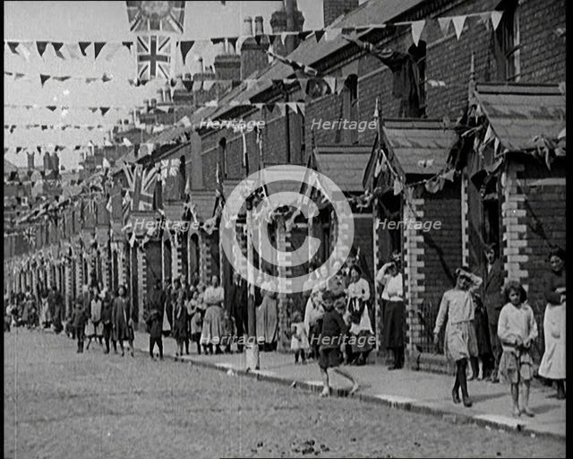 People Out the Front of Their Houses in a Street Decorated With Union Flag Bunting in Belfast, 1921. Creator: British Pathe Ltd.