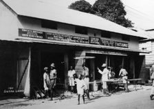People outside an undertaker's premises, Sierra Leone, 20th century