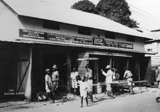 People outside an undertaker's premises, Sierra Leone, 20th century