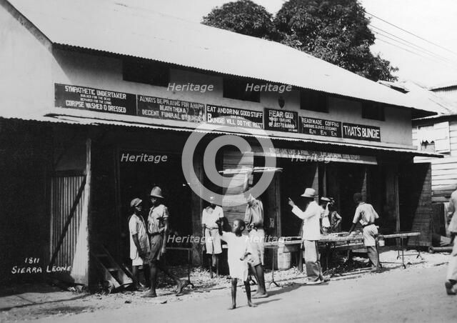 People outside an undertaker's premises, Sierra Leone, 20th century. Artist: Unknown