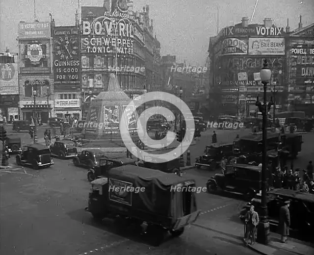 People and Traffic Moving Through a Busy Junction in London, 1943. Creator: British Pathe Ltd.