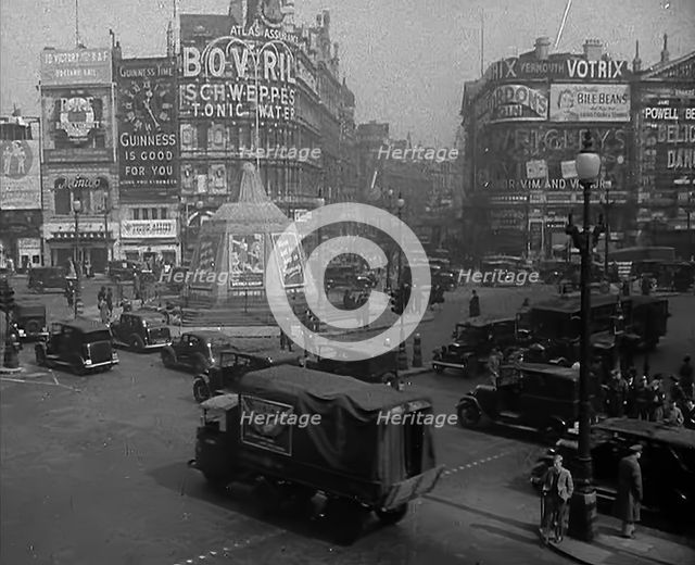 People and Traffic Moving Through a Busy Junction in London, 1943. Creator: British Pathe Ltd.