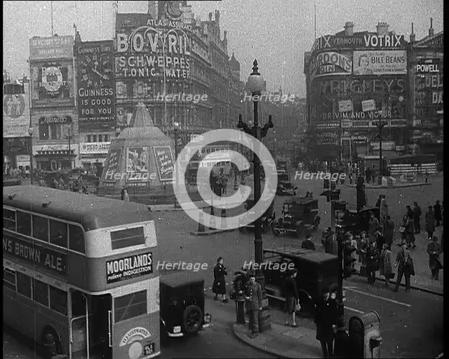People and Traffic Moving Through Piccadilly Circus in London, 1940.  Creator: British Pathe Ltd.