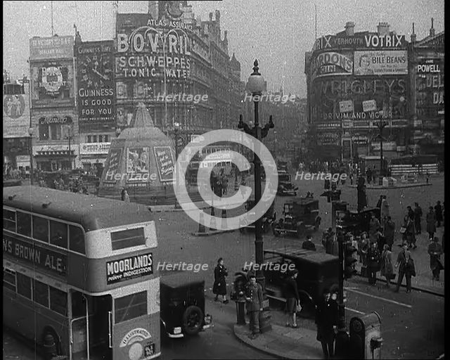 People and Traffic Moving Through Piccadilly Circus in London, 1940.  Creator: British Pathe Ltd.