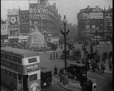 People and Traffic Moving Through Piccadilly Circus in London, 1940. Creator: British Pathe Ltd