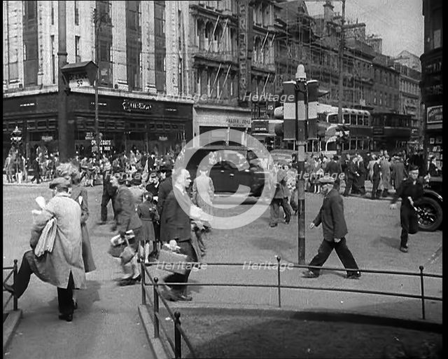People and Traffic Moving Along Crowded Streets, 1940. Creator: British Pathe Ltd.