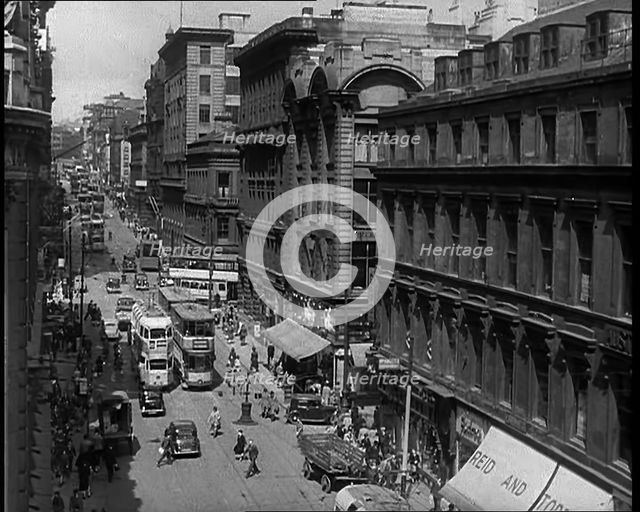 People and Traffic Moving Along Crowded Streets, 1940. Creator: British Pathe Ltd.