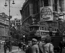 People and Traffic Moving Around a City, 1941. Creator: British Pathe Ltd