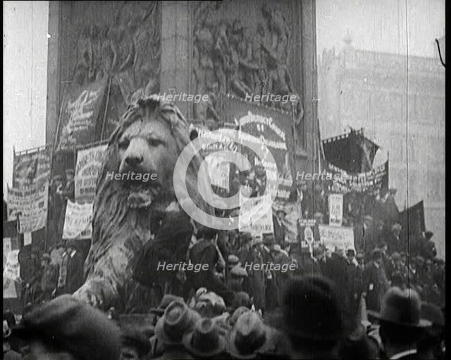 People Climbing Over the Lions at the Foot of Nelson's Column in Trafalgar Square, London..., 1922. Creator: British Pathe Ltd.