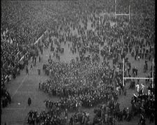 People Crowding the Pitch After an American Football Game, 1922. Creator: British Pathe Ltd