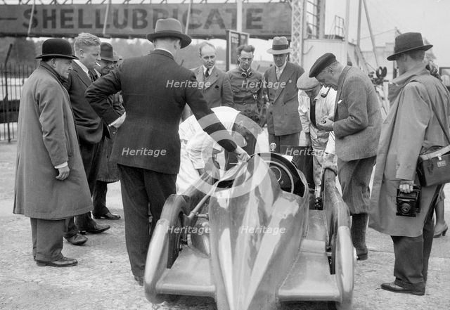 People examining Leon Cushman's Austin 7 racer at Brooklands for a speed record attempt, 1931. Artist: Bill Brunell.
