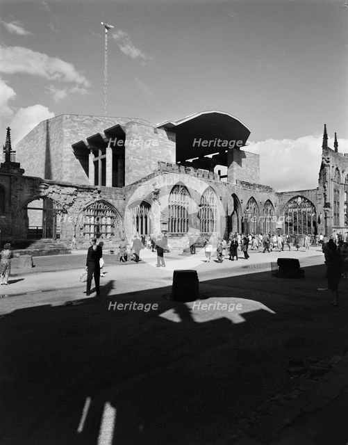 People exploring the ruins of the Cathedral Church of St Michael, Coventry, 1962.  Creator: John Laing plc.
