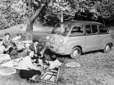 People enjoying a picnic beside a 1956 Fiat 600 Multipla, (c1956?)