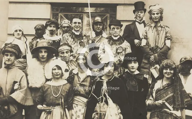 People gathered outside a building wearing various costumes, some in drag, 1924. Creator: Unknown.