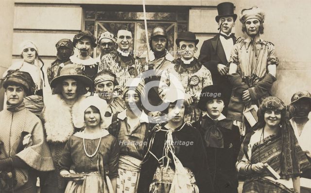 People gathered outside a building wearing various costumes, some in drag, 1924. Creator: Unknown.