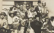 People gathered outside a building wearing various costumes, some in drag, 1924. Creator: Unknown