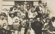 People gathered outside a building wearing various costumes, some in drag, 1924. Creator: Unknown