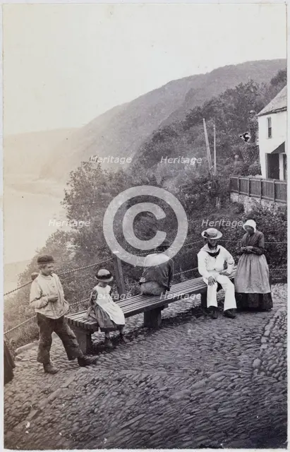 People gathered by the bench at the Lookout in Clovelly, 1860s. Creator: Unknown.