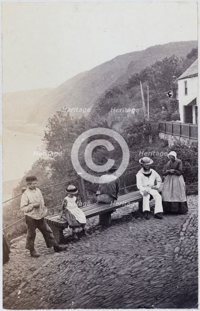 People gathered by the bench at the Lookout in Clovelly, 1860s. Creator: Unknown.