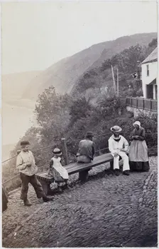 People gathered by the bench at the Lookout in Clovelly, 1860s. Creator: Unknown