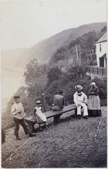 People gathered by the bench at the Lookout in Clovelly, 1860s. Creator: Unknown
