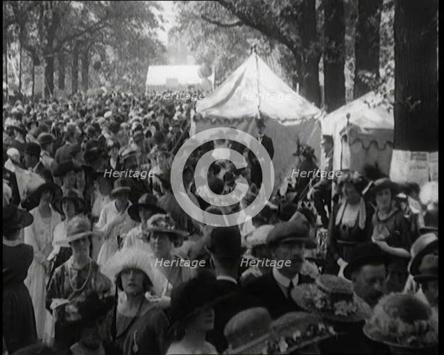 People Gathering and Relaxing at a Fairground Between Marquees and Balloons, 1920. Creator: British Pathe Ltd.