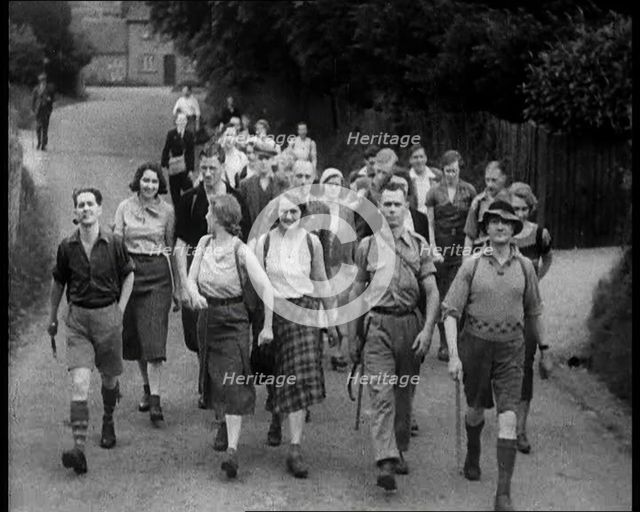 People Hiking Down a Road Towards the Camera, 1933. Creator: British Pathe Ltd.