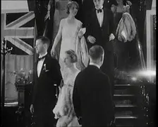 People in Evening Dress Walking Down Stairs, 1931. Creator: British Pathe Ltd